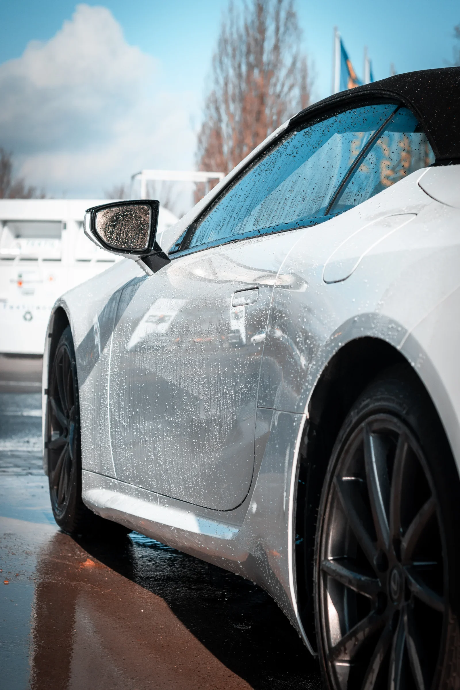 Myčka u Makra v Plzni: modrý přístřešek s nápisem Car Wash Center a auta v mycích boxech
